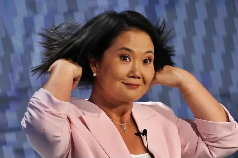 Primer plano de la candidata Keiko Fujimori con una expresión facial enfática mientras sostiene su cabello con ambas manos.